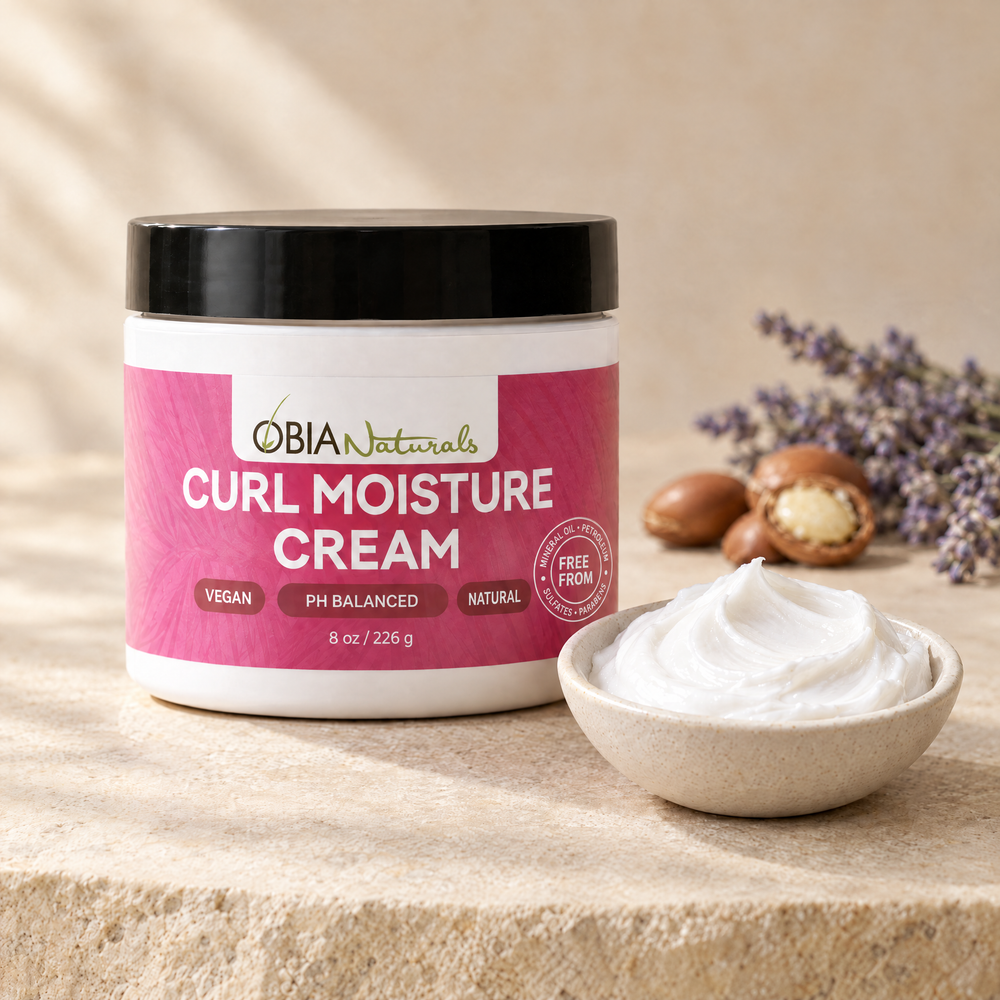 Curl Moisture Cream texture — a swirl of the lightweight white leave-in cream beside the jar, with argan nuts and lavender