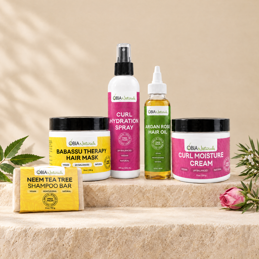 Type 3 Moisture Bundle on a stone plinth: Neem Tea Tree bar, Hair Therapy Mask, Hydration Spray, Argan Rose Oil, Curl Cream