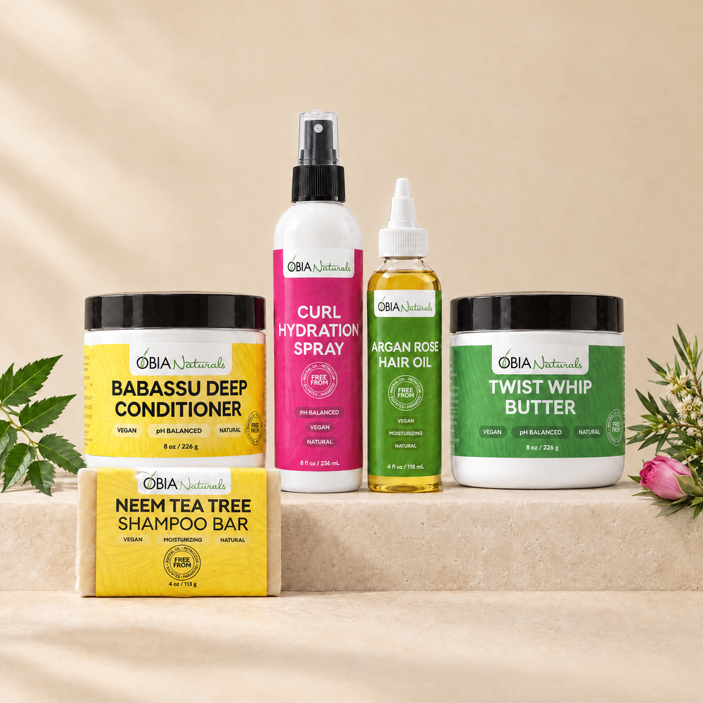 OBIA Naturals Type 4 Moisture Bundle with Neem Tea Tree Shampoo Bar — shampoo bar, Babassu Deep Conditioner, Curl Hydration Spray, Argan Rose Hair Oil and Twist Whip Butter arranged on a stone plinth