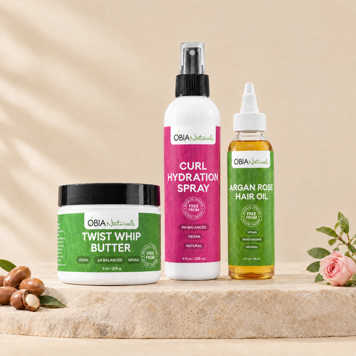 OBIA Naturals Perfect Twist Out Bundle — Twist Whip Butter, Curl Hydration Spray and Argan Rose Hair Oil arranged on a stone plinth